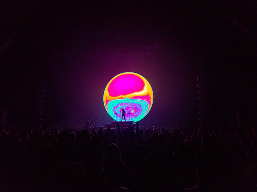 A colorful waveform visualization pulsing across a large screen during a live session.