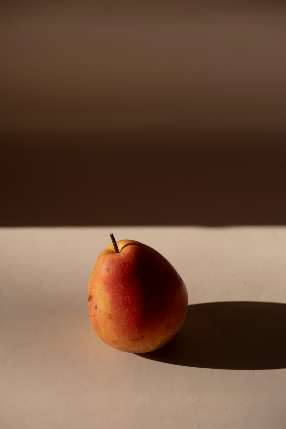 an apple sitting on top of a white table