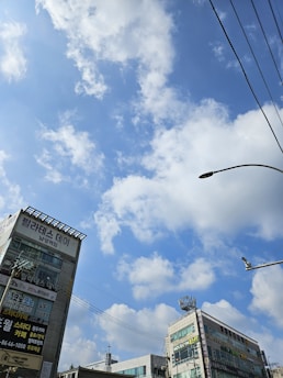 A cityscape of Kansas City with a subtle overlay of language icons representing Spanish, English, and Chinese.