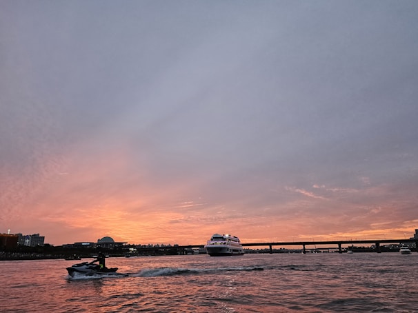 A picturesque sunset view over a yacht with water toys ready for fun.