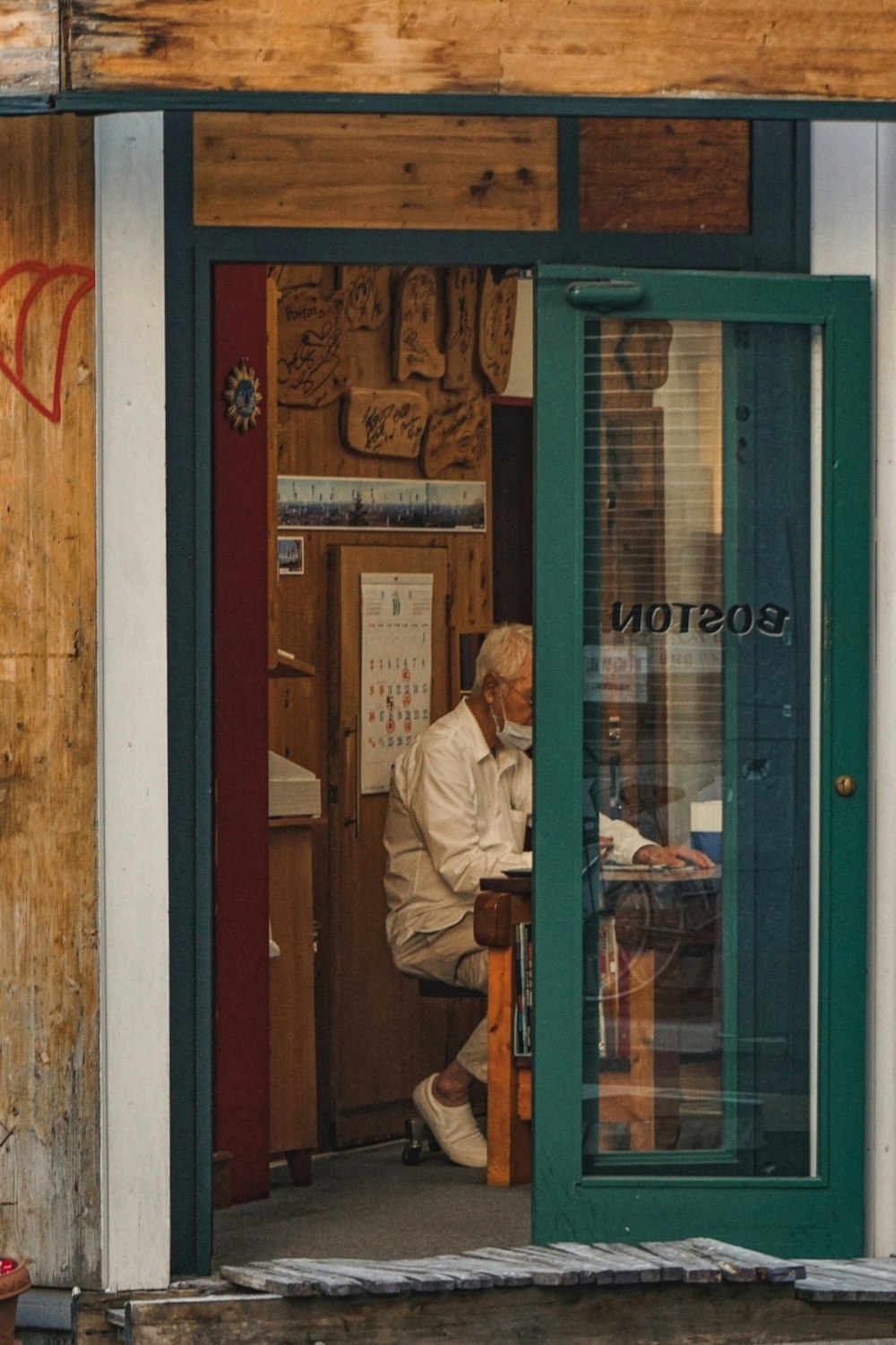 a man sitting at a table outside of a store
