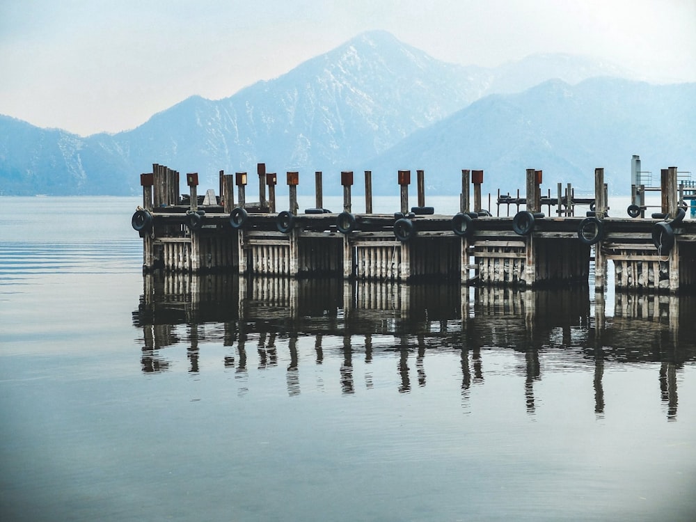 a large body of water with a dock in the middle of it