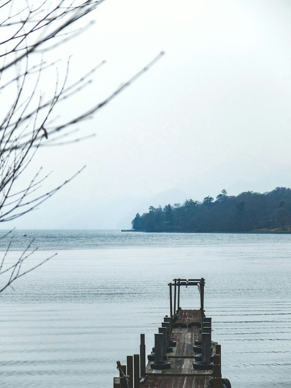 a wooden dock sitting in the middle of a large body of water