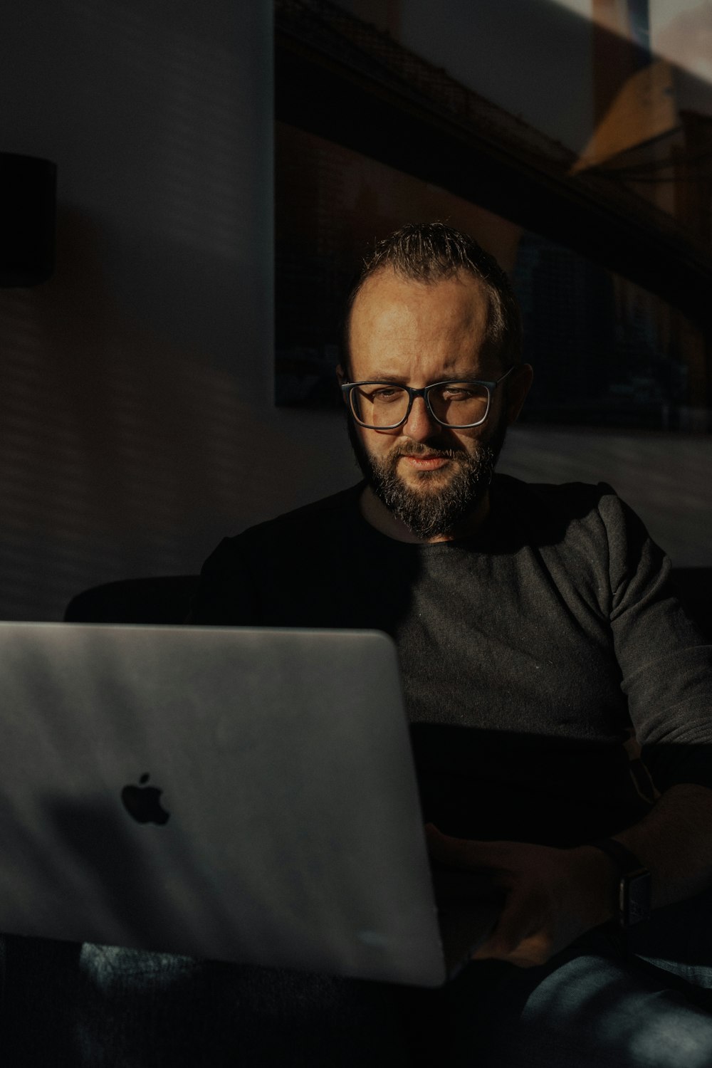 a man sitting in front of a laptop computer