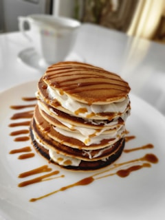 A delicious breakfast spread with pancakes and syrup.
