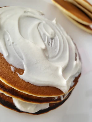 Close-up of sugar-free pancake batter being poured into a fun animal-shaped mold.