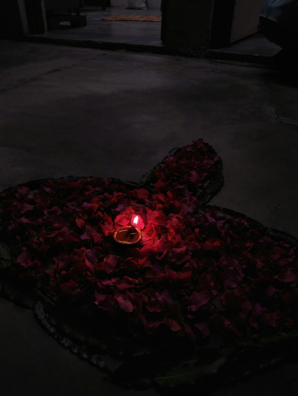 a heart shaped object with a lit candle in it