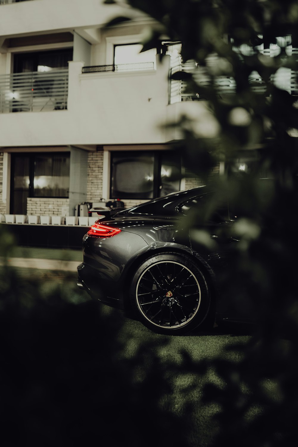 a black sports car parked in front of a building