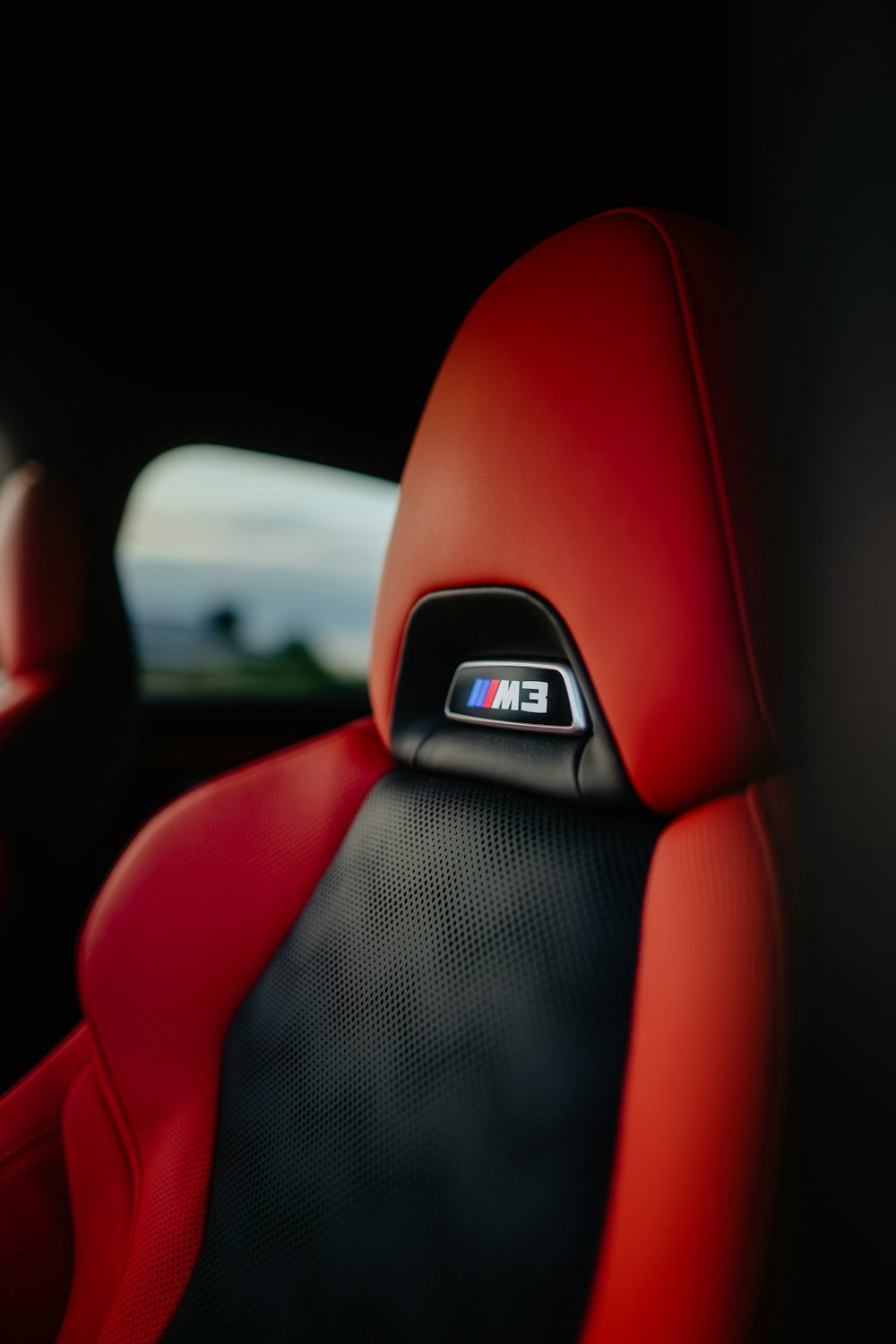 the interior of a car with a red leather seat