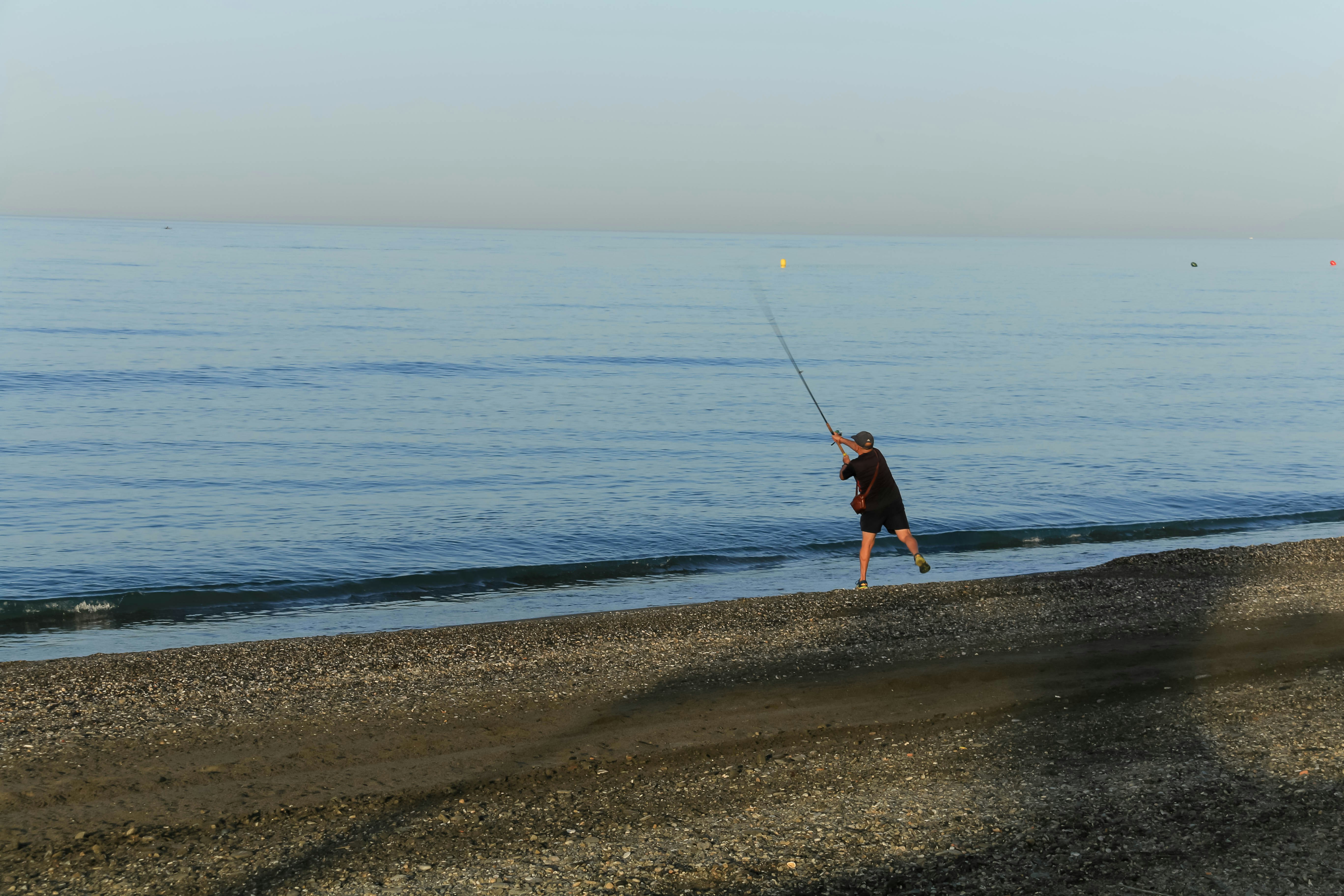 a man is flying a kite on the beach