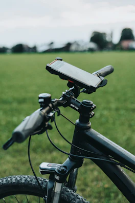 A cyclist mounting a sports camera on a bike handlebar with a sturdy bike mount.