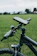 Close-up of a sleek phone mount attached to a motorcycle handlebar on a sunny day.