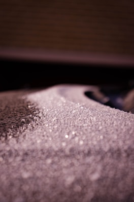 Close-up of a cryotherapy unit with frost forming on its metallic surface under clinical lighting.