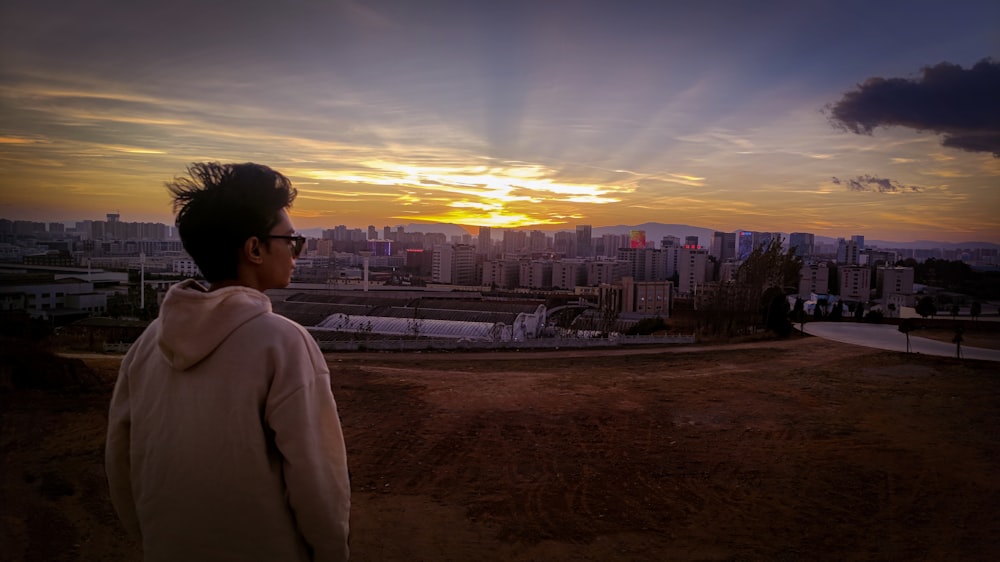 a man standing on top of a dirt field