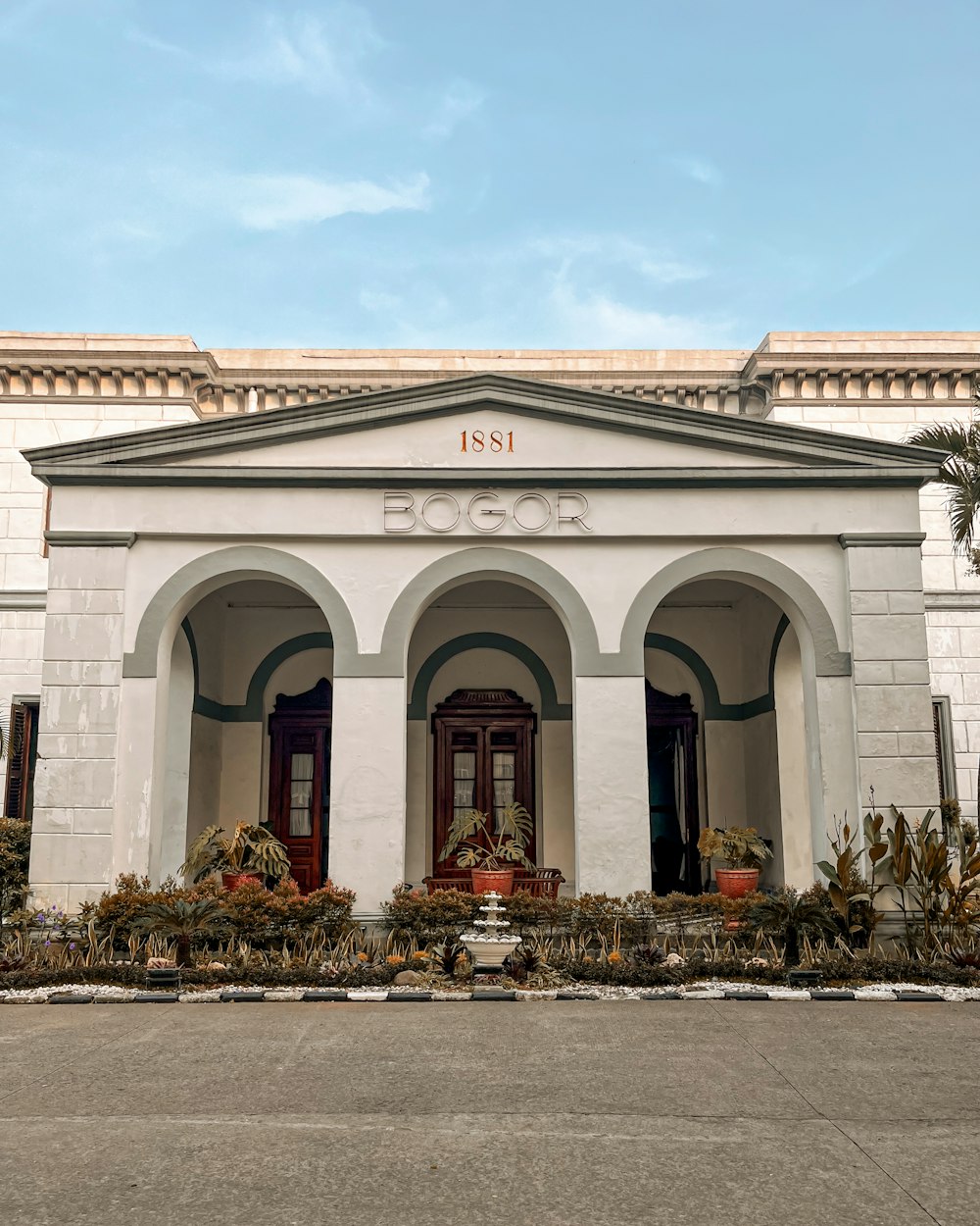 a large white building with a clock on the front of it