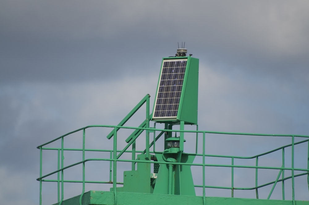 a solar panel on top of a green structure