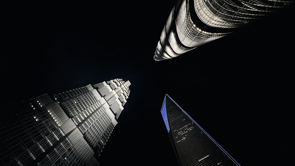 looking up at two skyscrapers at night
