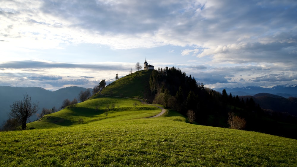 a grassy hill with a church on top of it