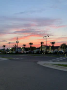 Photo of a well-lit commercial parking lot at dusk in San Marcos.