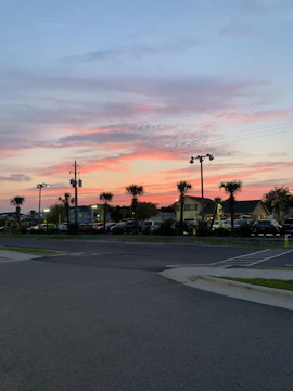 Photo of a well-lit commercial parking lot at dusk in San Marcos.