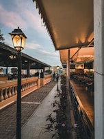 A cozy café terrace bathed in soft royal blue evening light, inviting quiet moments of reflection.