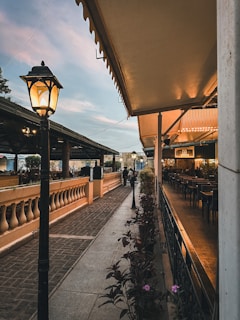 Outdoor terrace of a charming restaurant with flowers and soft evening light.