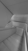 Contemporary staircase with minimalist design and monochrome tones.
