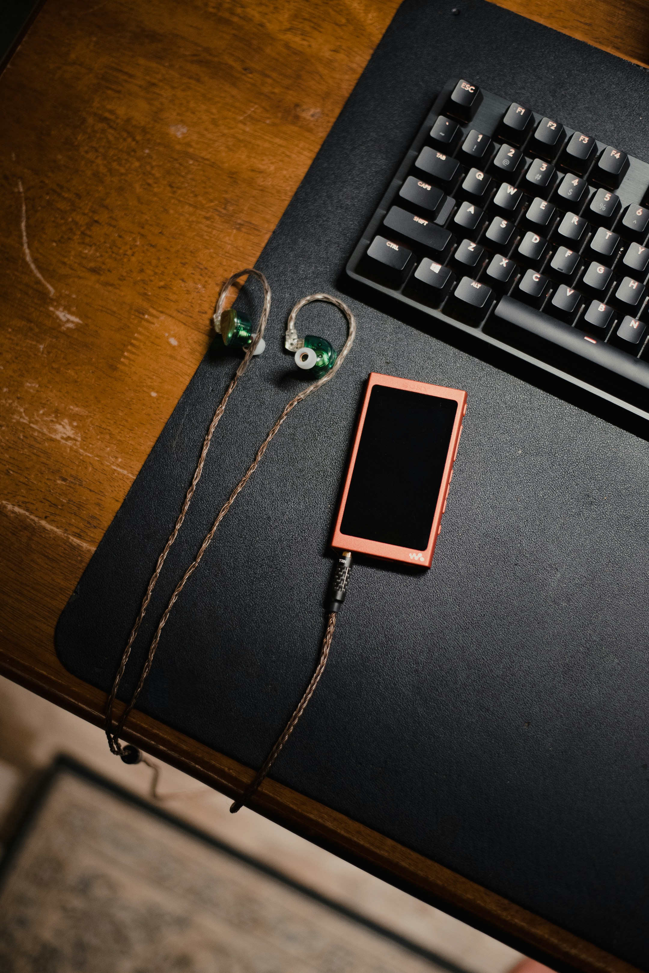 a cell phone sitting on top of a desk next to a keyboard