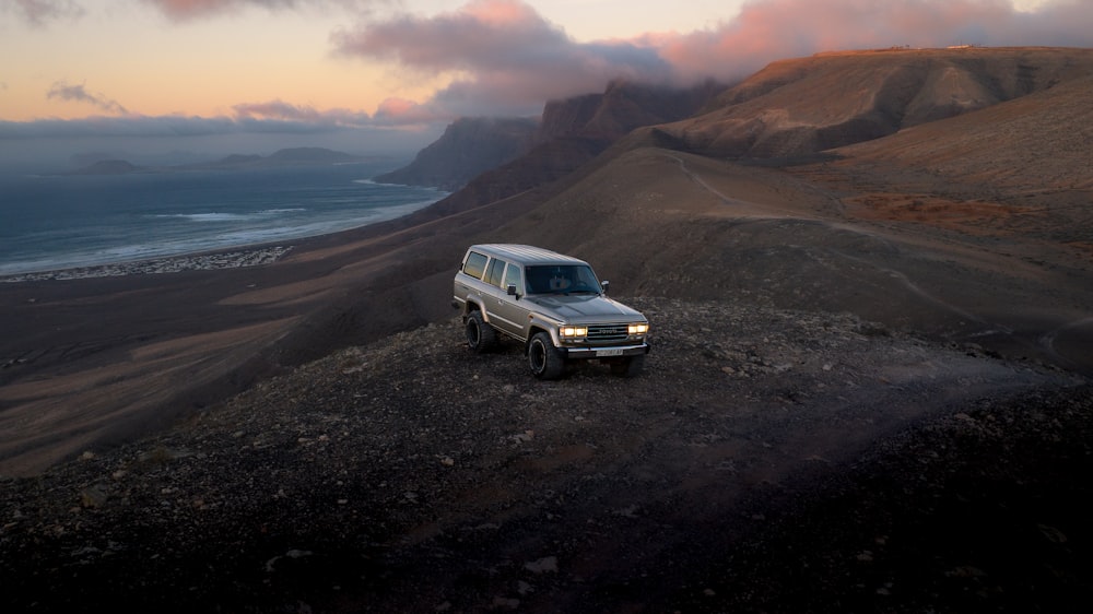 a white truck parked on top of a mountain