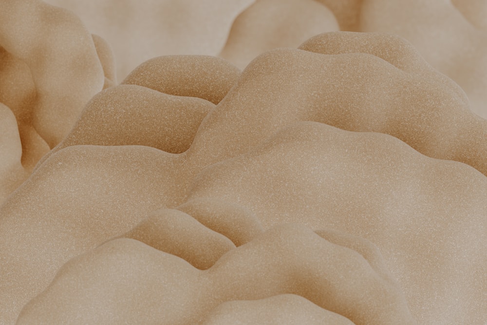 a close up of a sand dune with a sky background