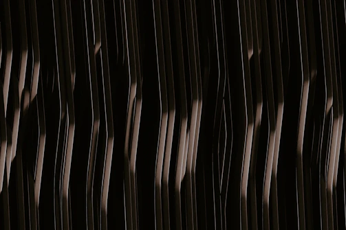 A UV printed creation featuring minimalist gold patterns on a dark background.