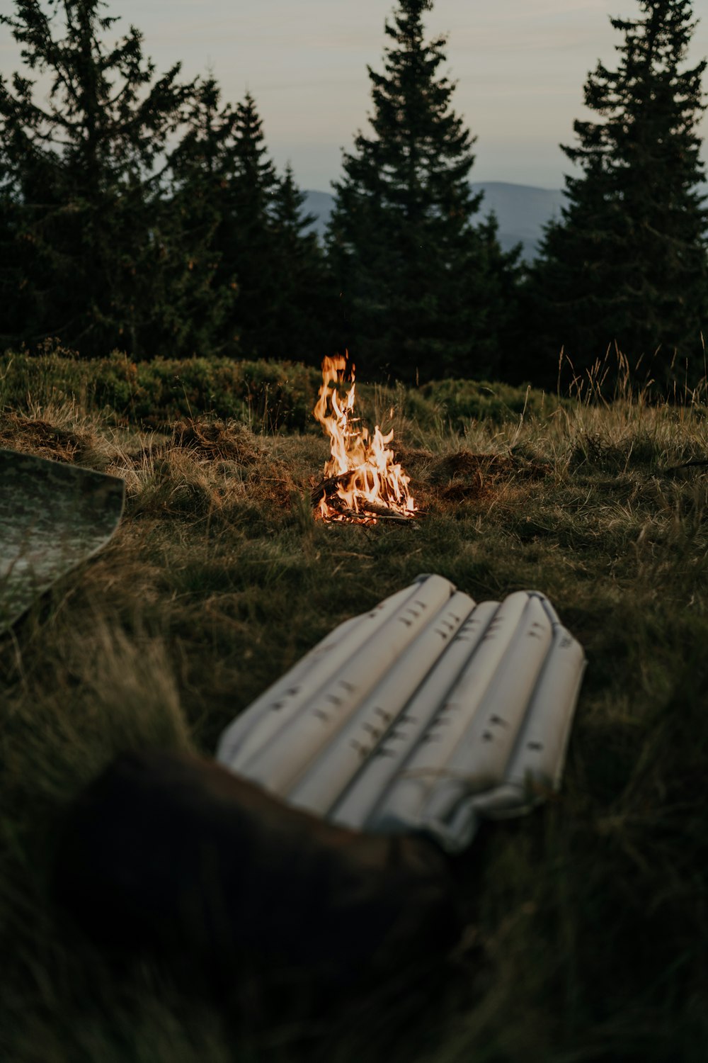 a campfire in the middle of a grassy field