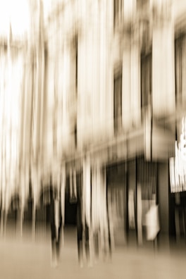 A sepia-toned photograph capturing a vintage Edwardian street scene.