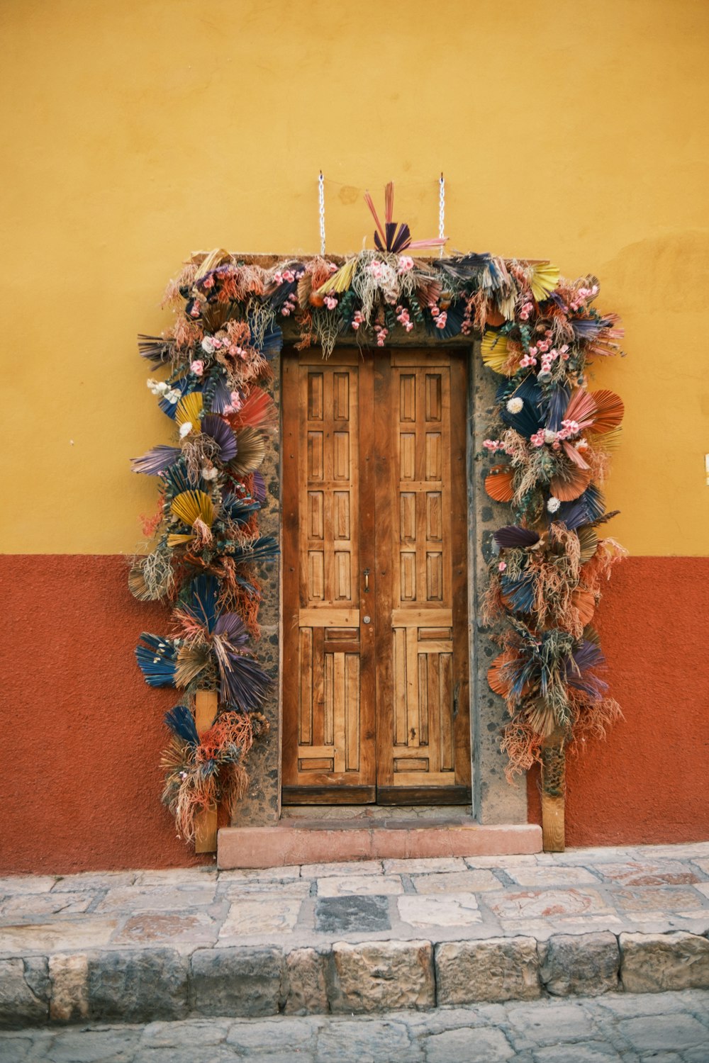 a wooden door with a bunch of flowers on it