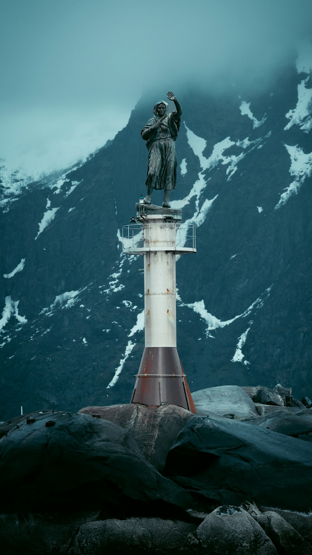 a lighthouse with a statue on top of it