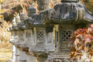 Close-up of intricately carved stone lanterns illuminating the peaceful grounds