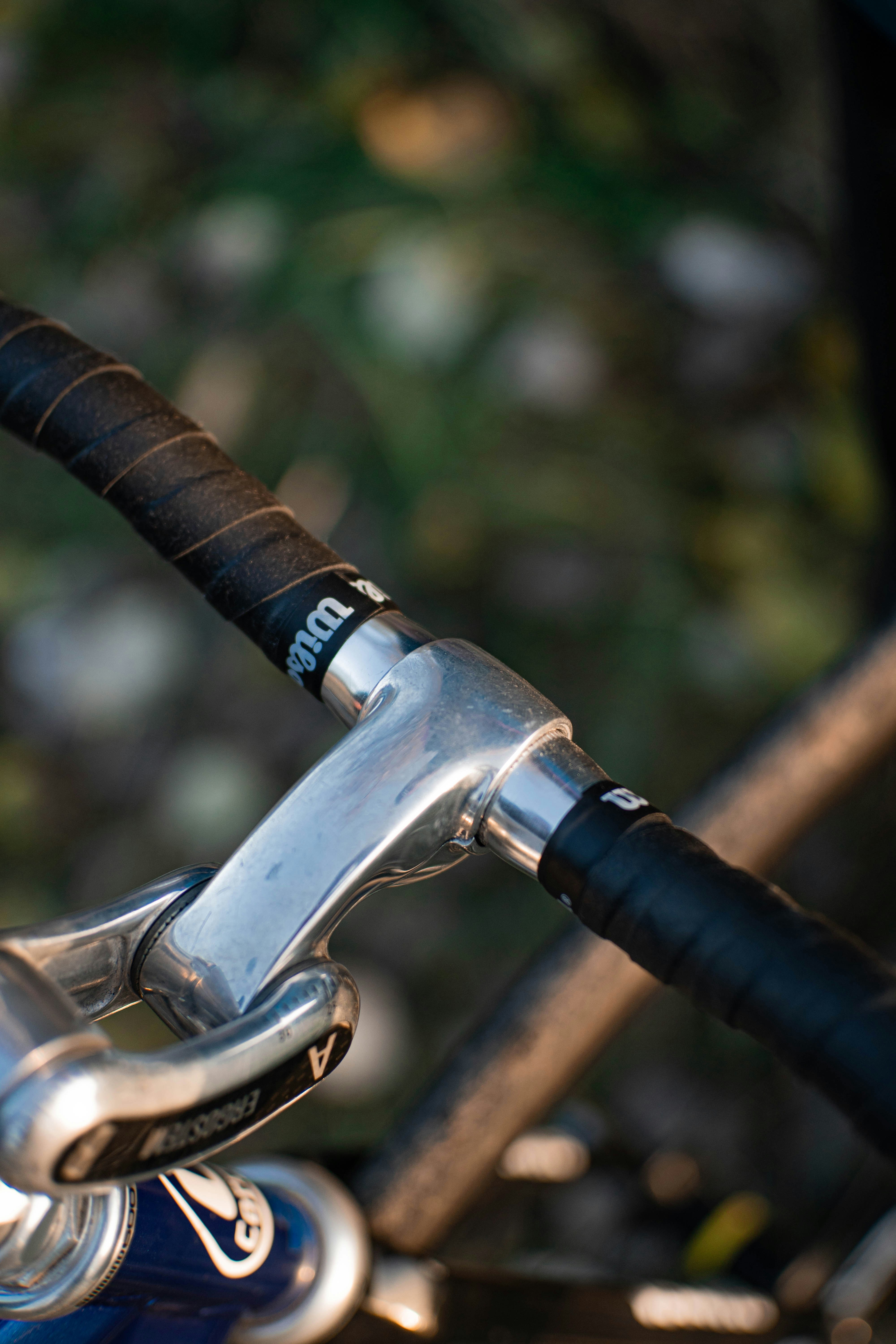 a close up of a bike handlebar with a blurry background