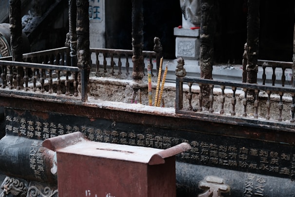 Close-up of a classic oriental incense burner with intricate carvings, emitting delicate smoke curls.
