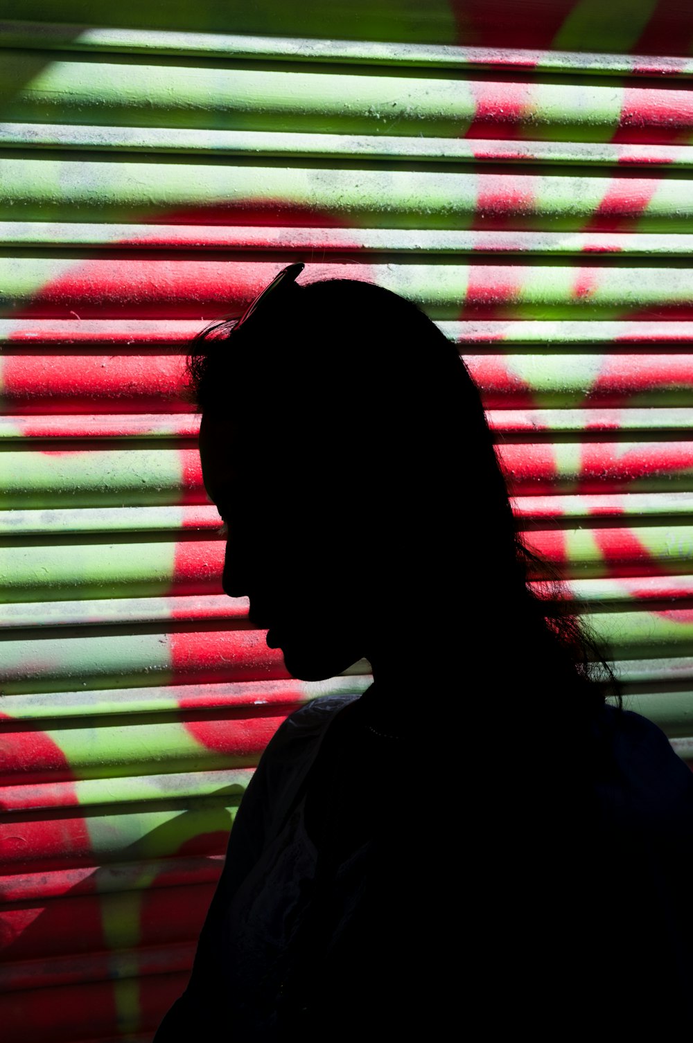 a silhouette of a person standing in front of a window