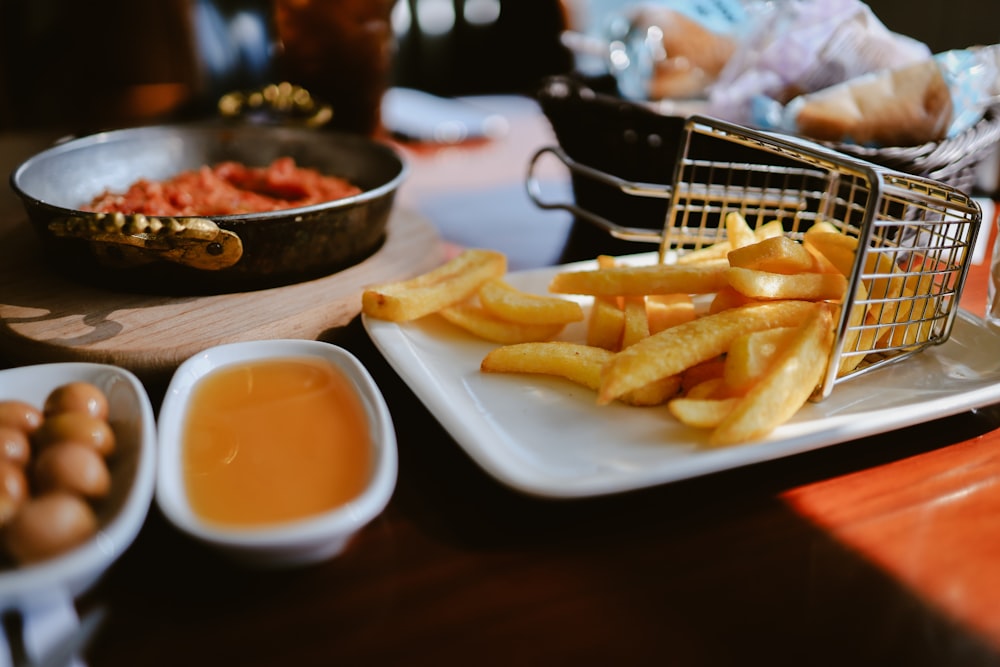 a basket of french fries sitting on top of a white plate