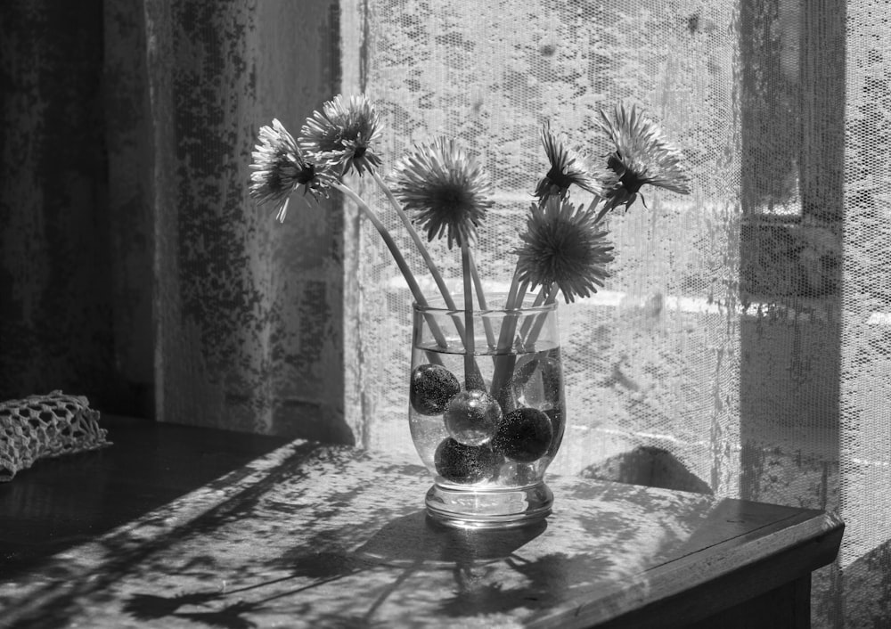 a vase of flowers sitting on a table