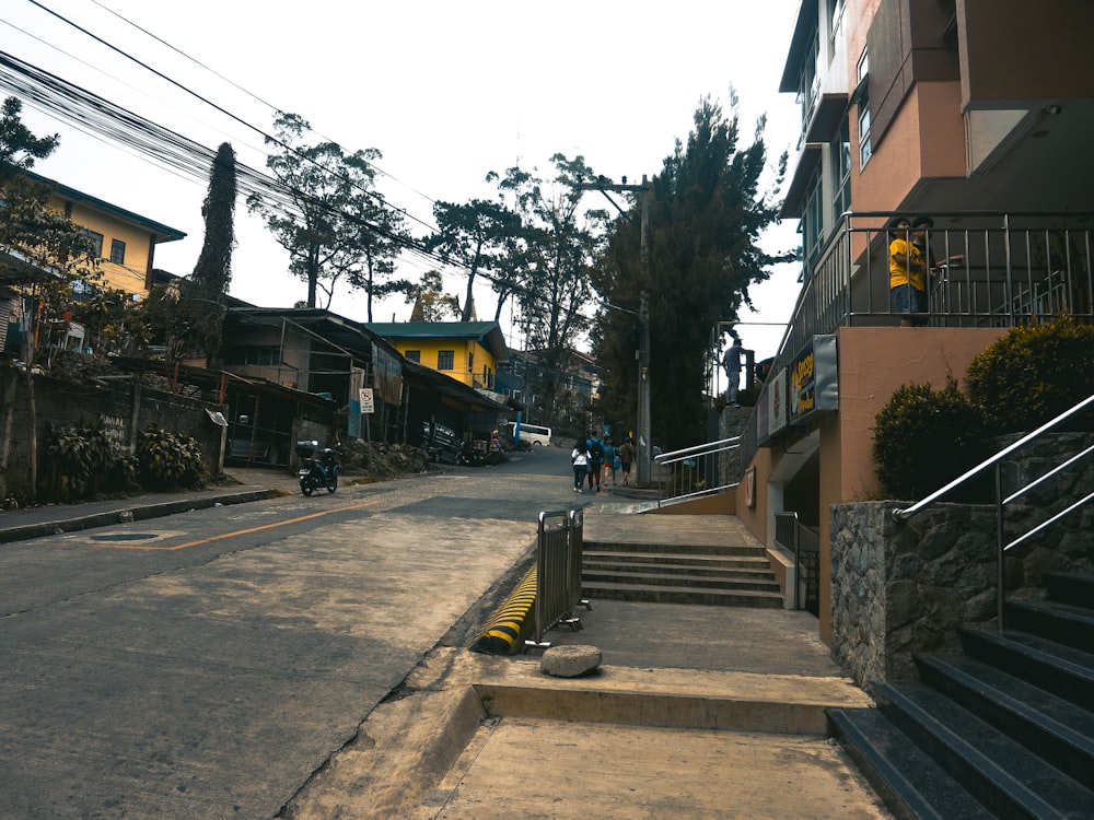 a city street with stairs leading up to buildings