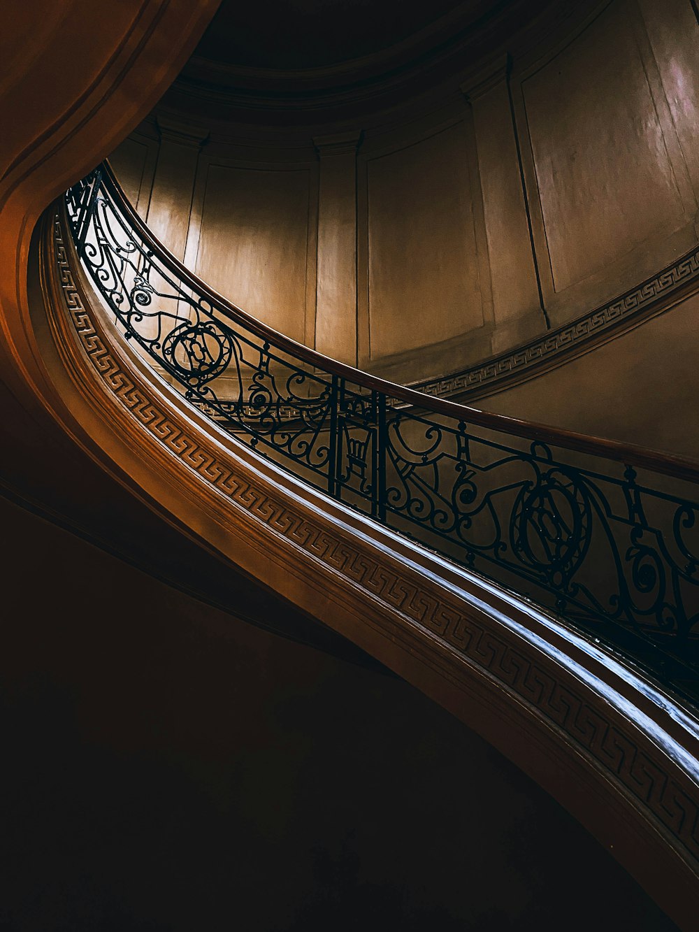 a spiral staircase in a building with a clock on it