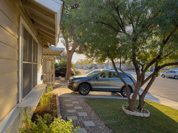A car parked in front of a single family home on a Las Vegas valley street
