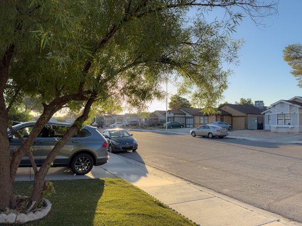 A quiet Las Vegas suburban street on a sunny morning, representing east Las Vegas neighborhoods served by Western and Desert Pines high schools