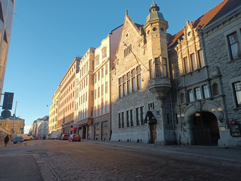 a street lined with tall buildings next to a traffic light