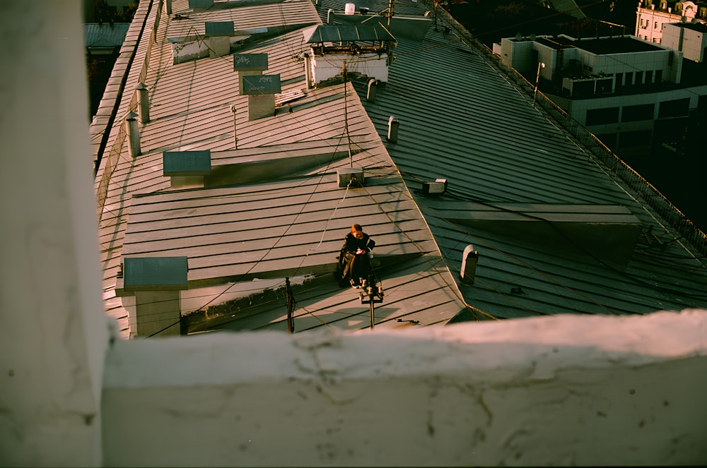 a man riding a bike on top of a roof