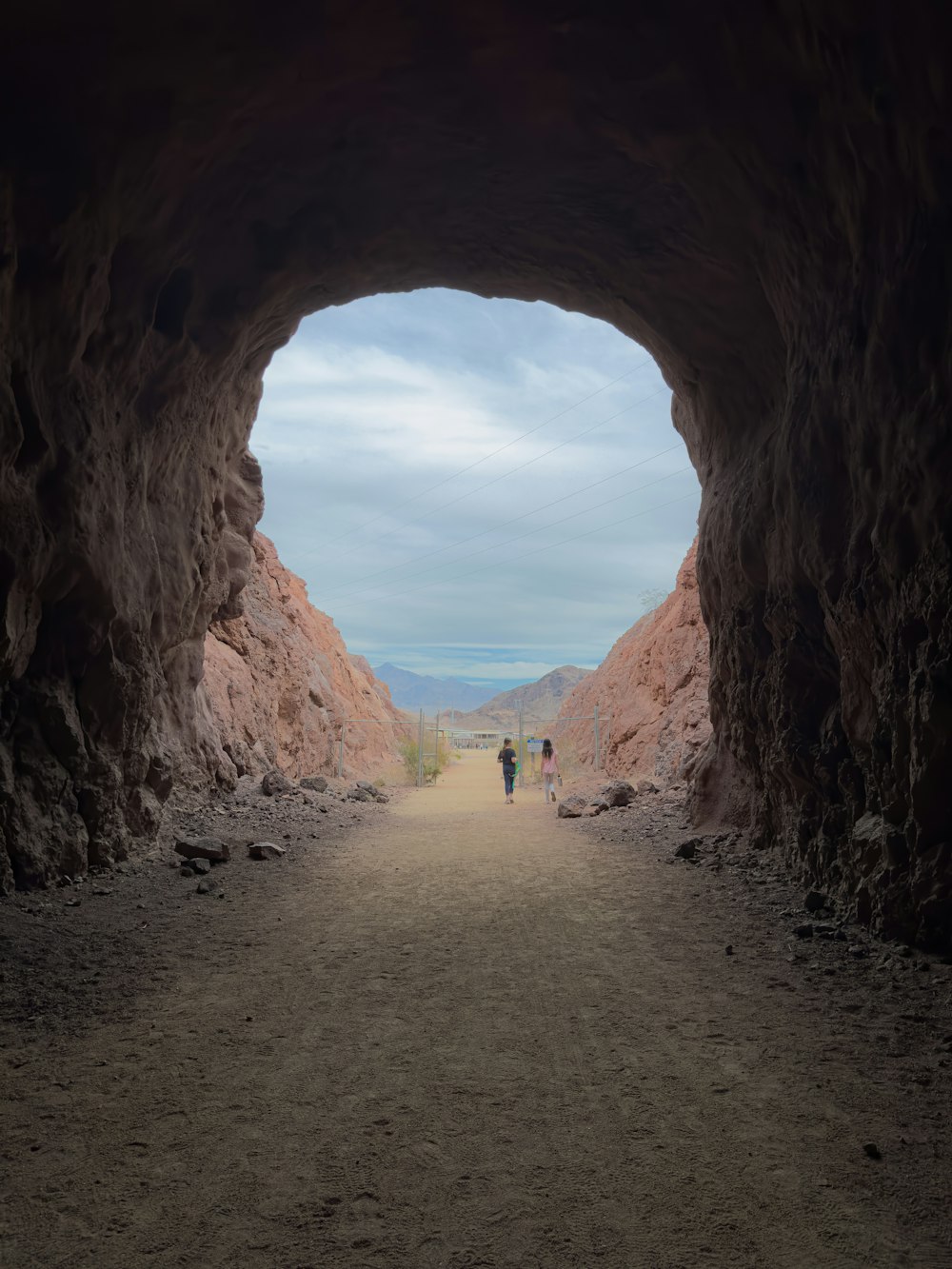 a couple of people that are standing in a cave