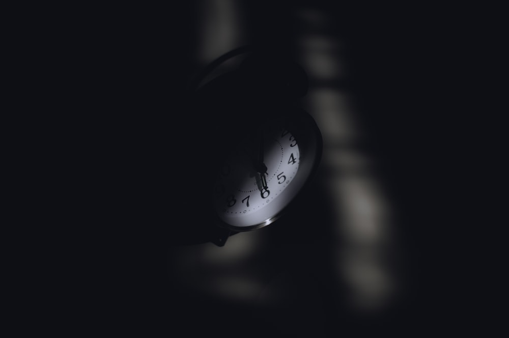 a close up of a clock in the dark