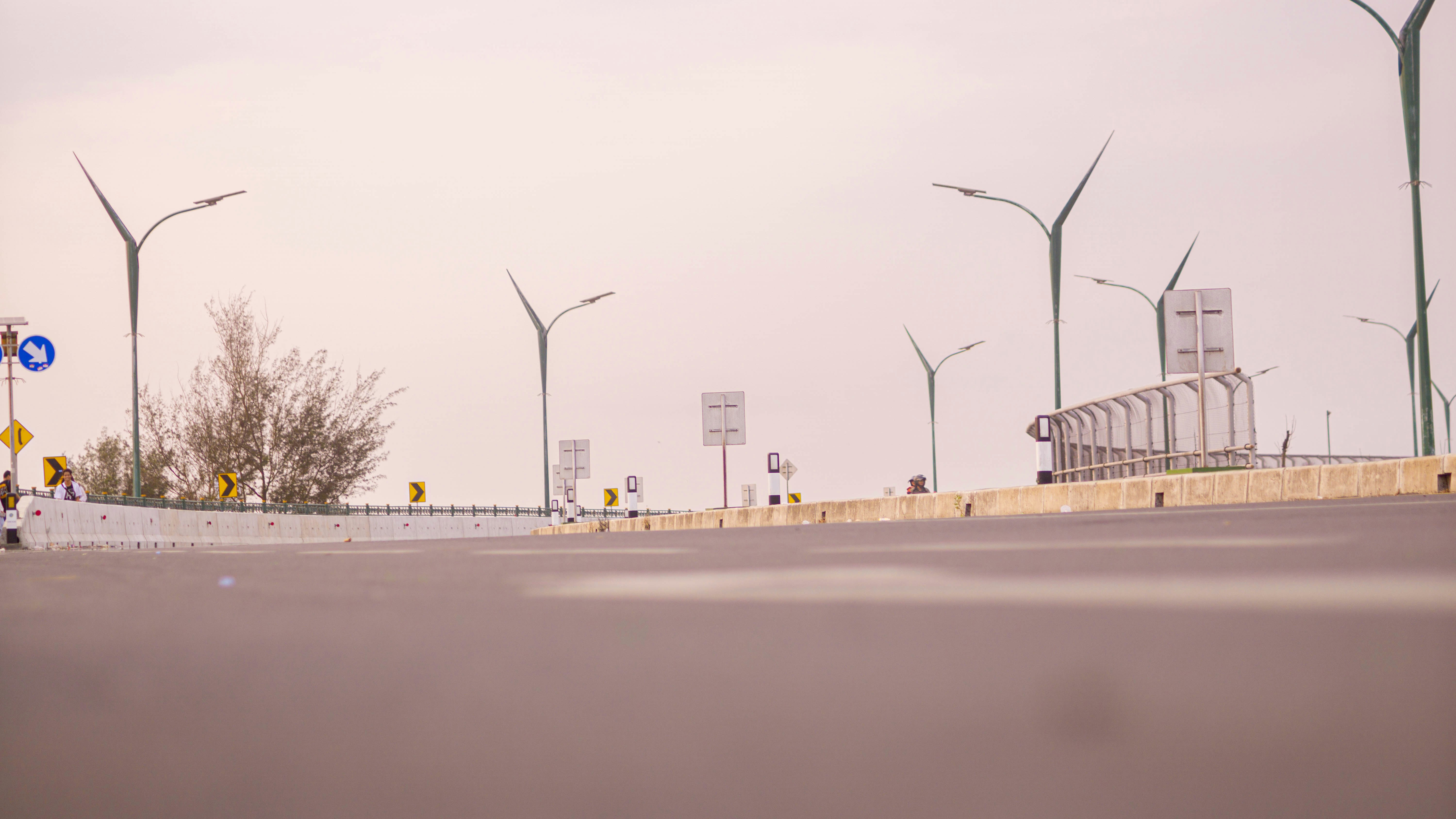 a group of street lights sitting next to a road